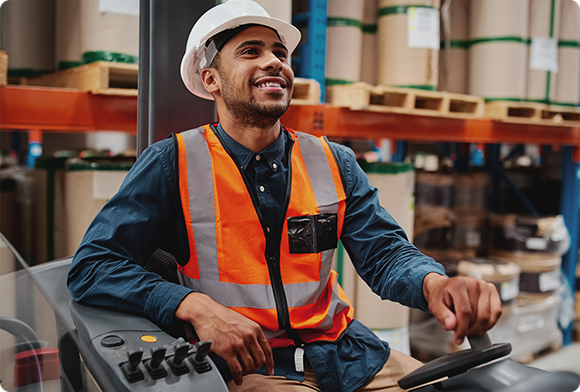 Warehouse worker operates machinery