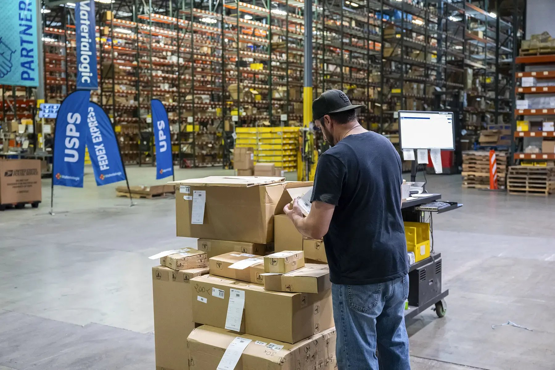 Warehouse worker using InfoPlus Warehouse Management Software for shipping orders