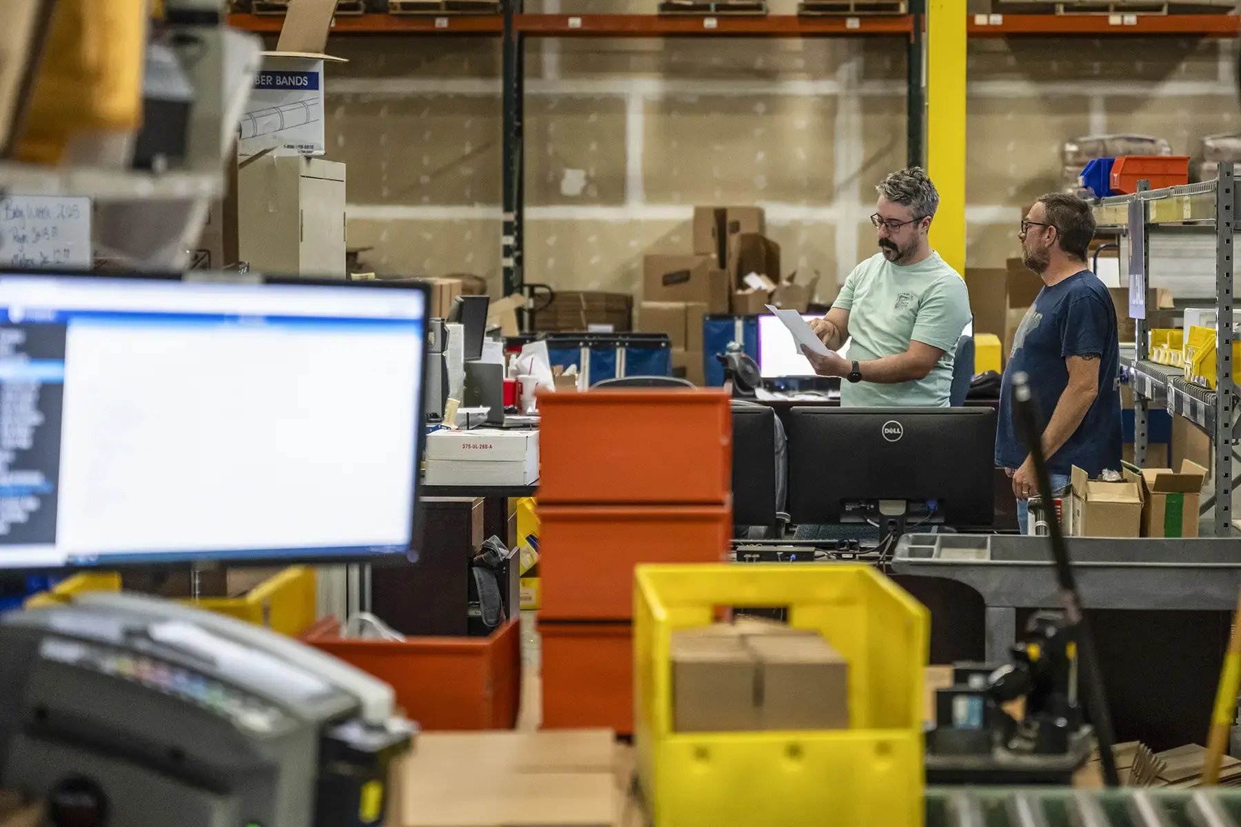 Two warehouse workers using InfoPlus warehouse management system