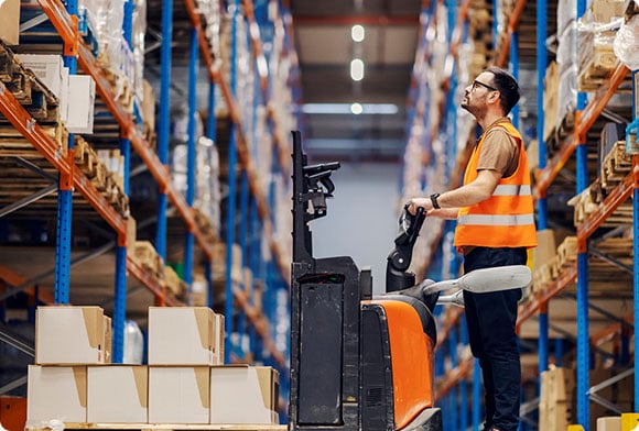 A warehouse worker puts away inventory